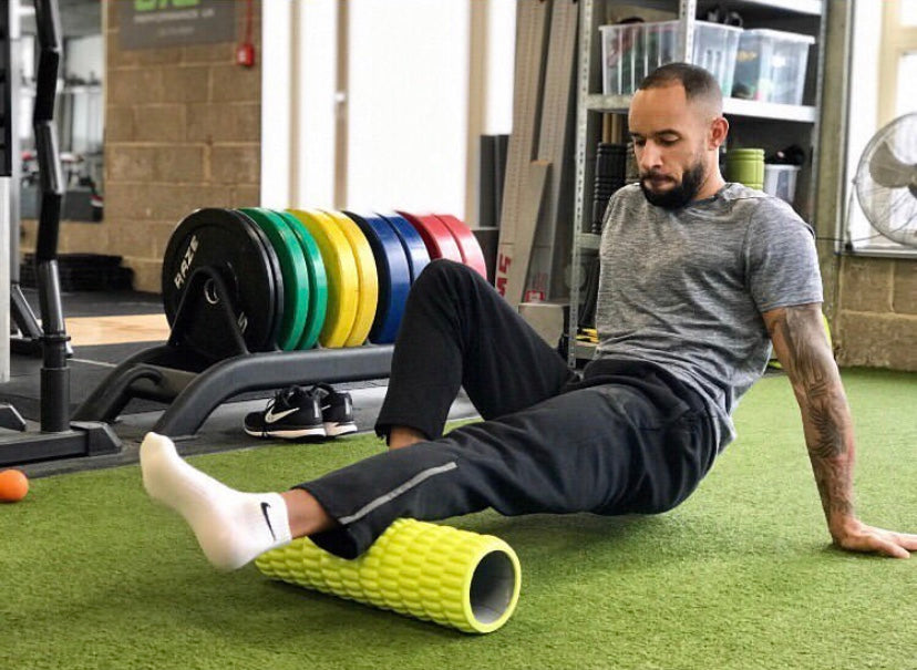 A man using foam roller for the first time